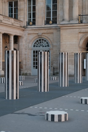 A large building with columns and benches in front of it