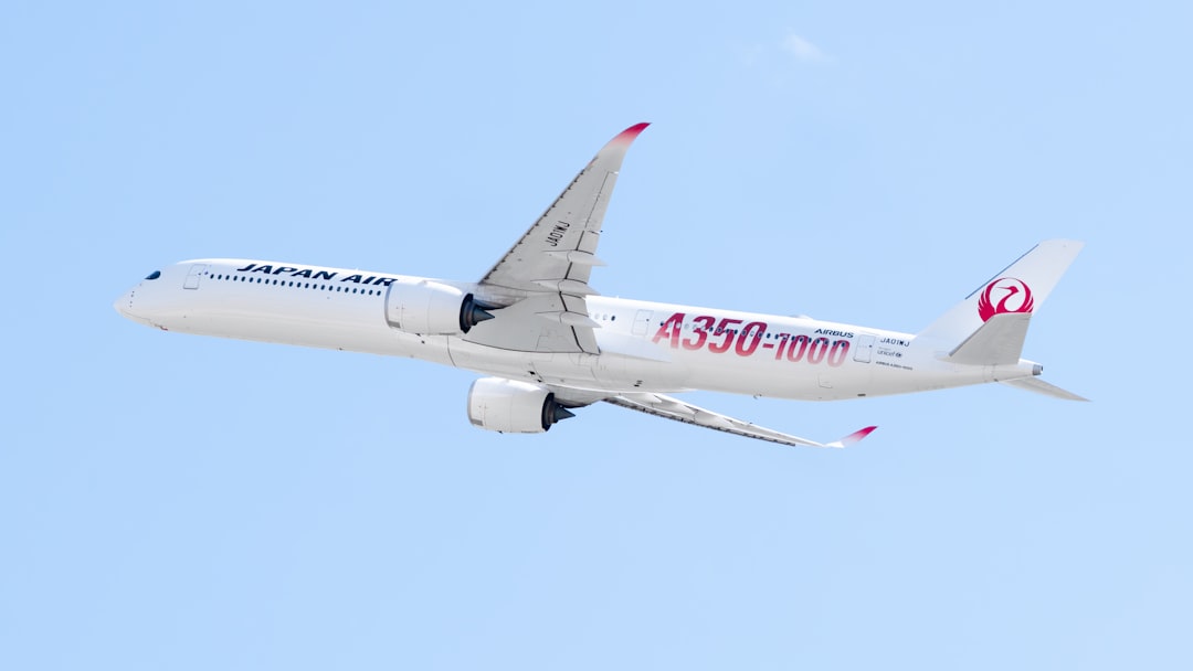 A large jetliner flying through a blue sky, Japan Airlines 1st Airbus A350-1000 in the special