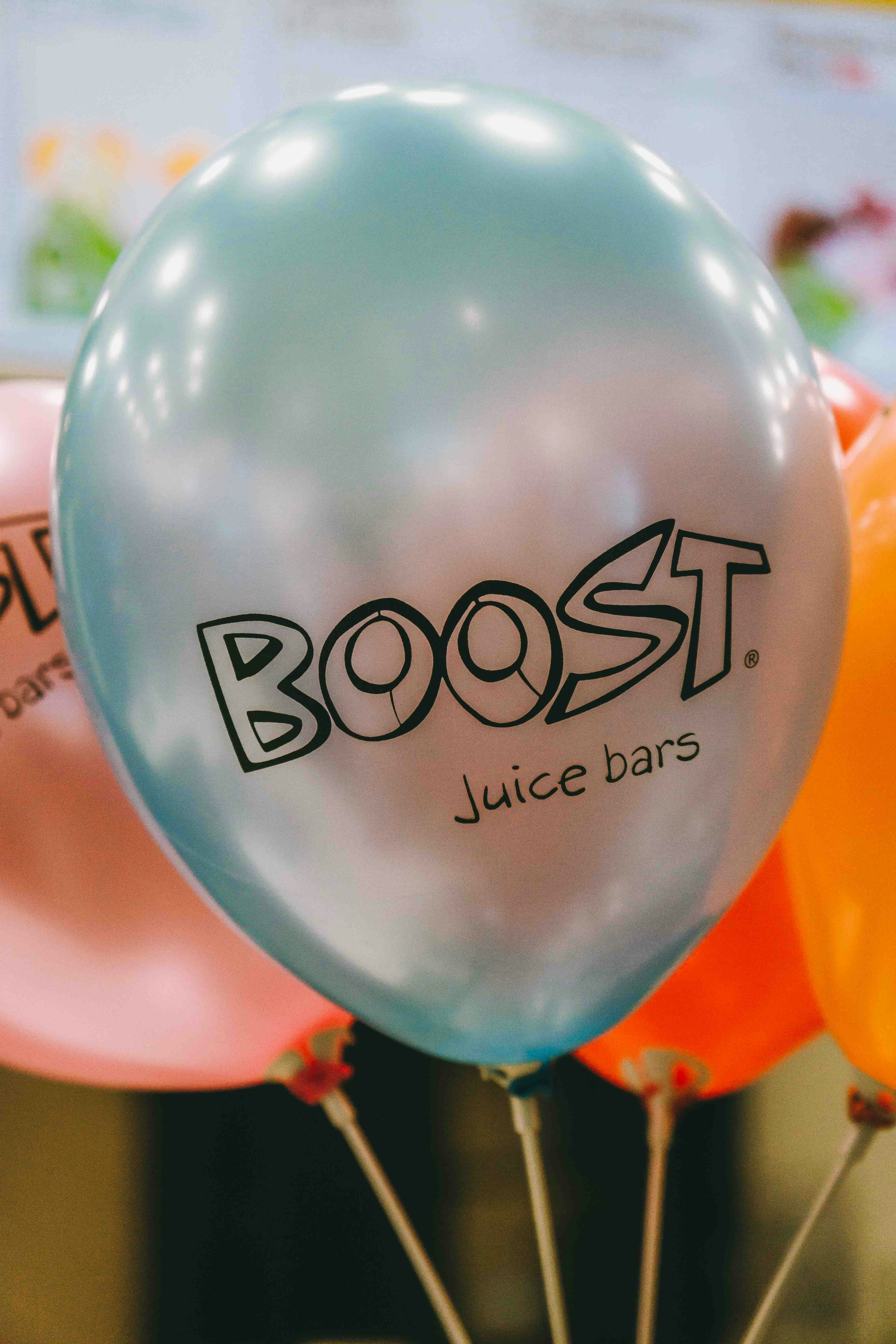 A bunch of balloons with the words boost on them