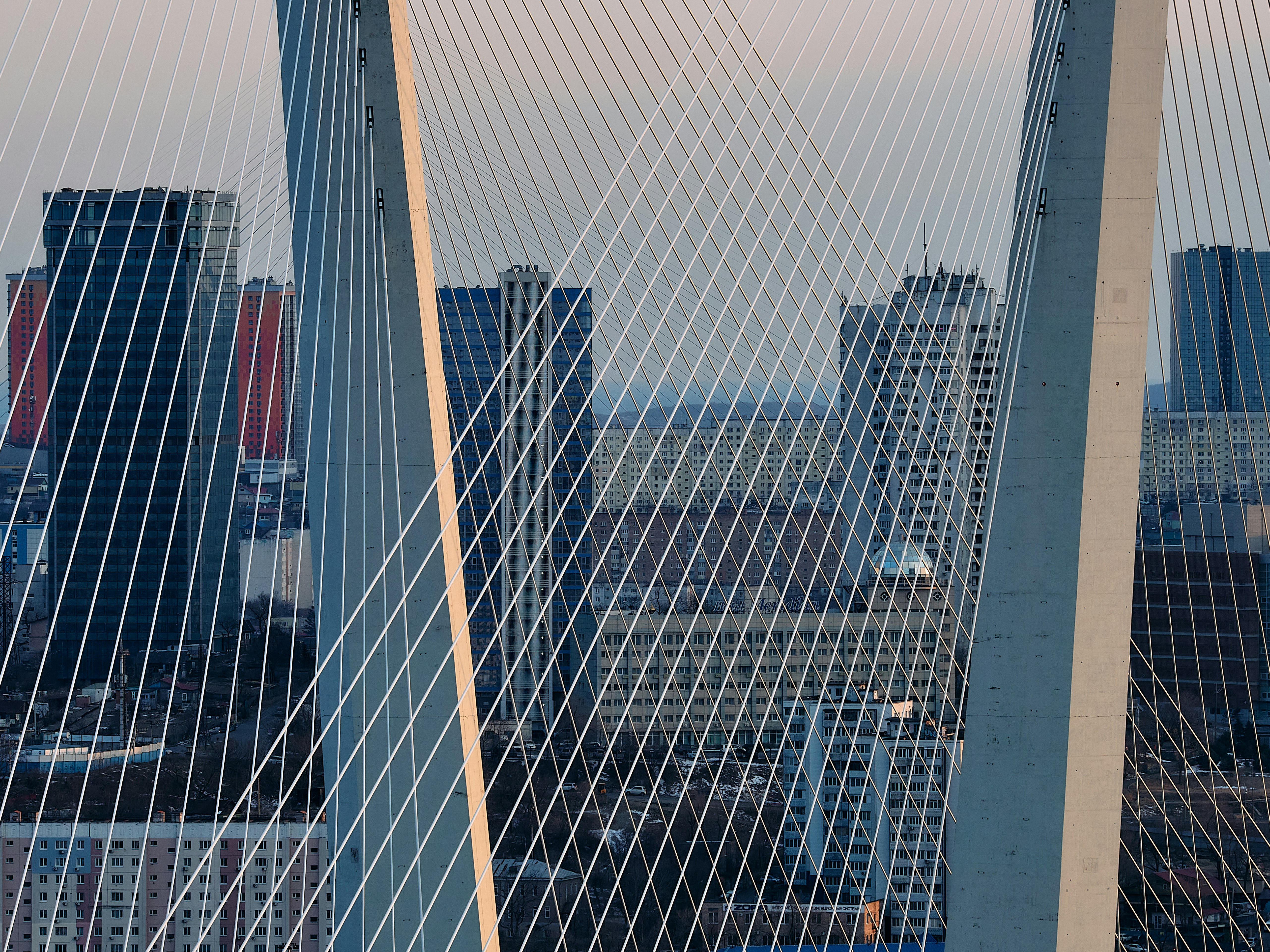 A view of a bridge with a city in the background