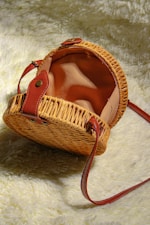 A wicker purse sitting on top of a white rug