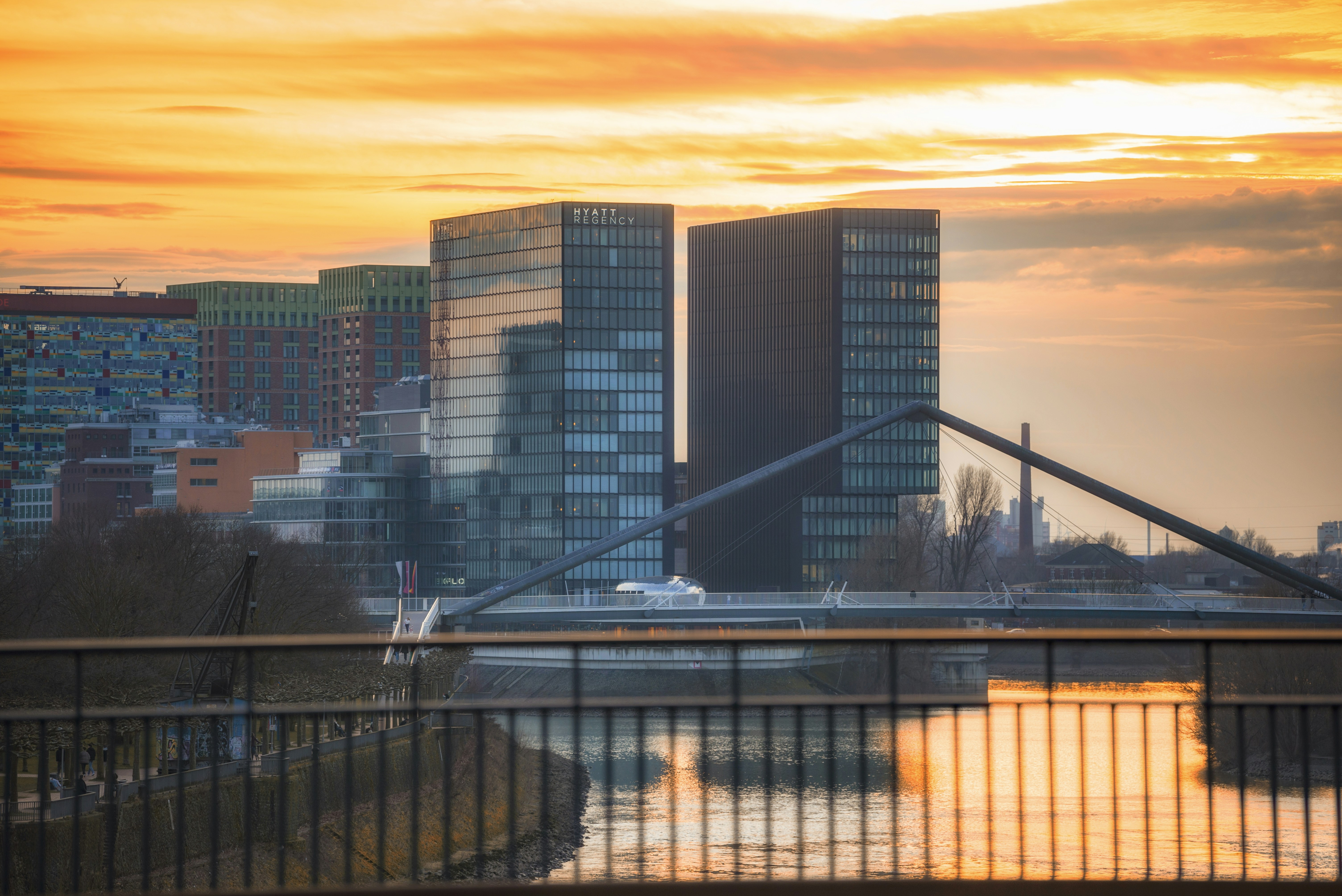 A bridge over a river with a city in the background