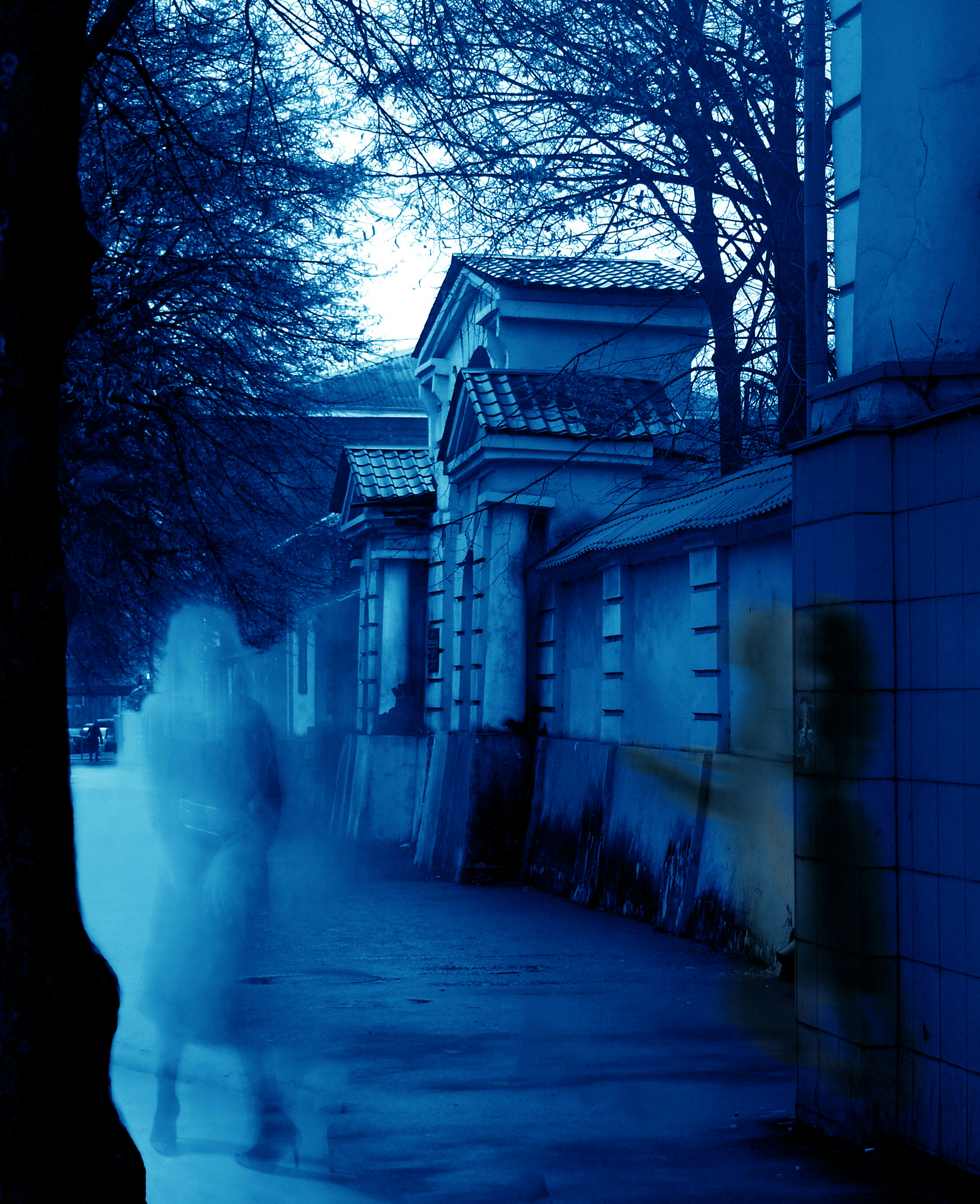 A blurry photo of a person walking down a street