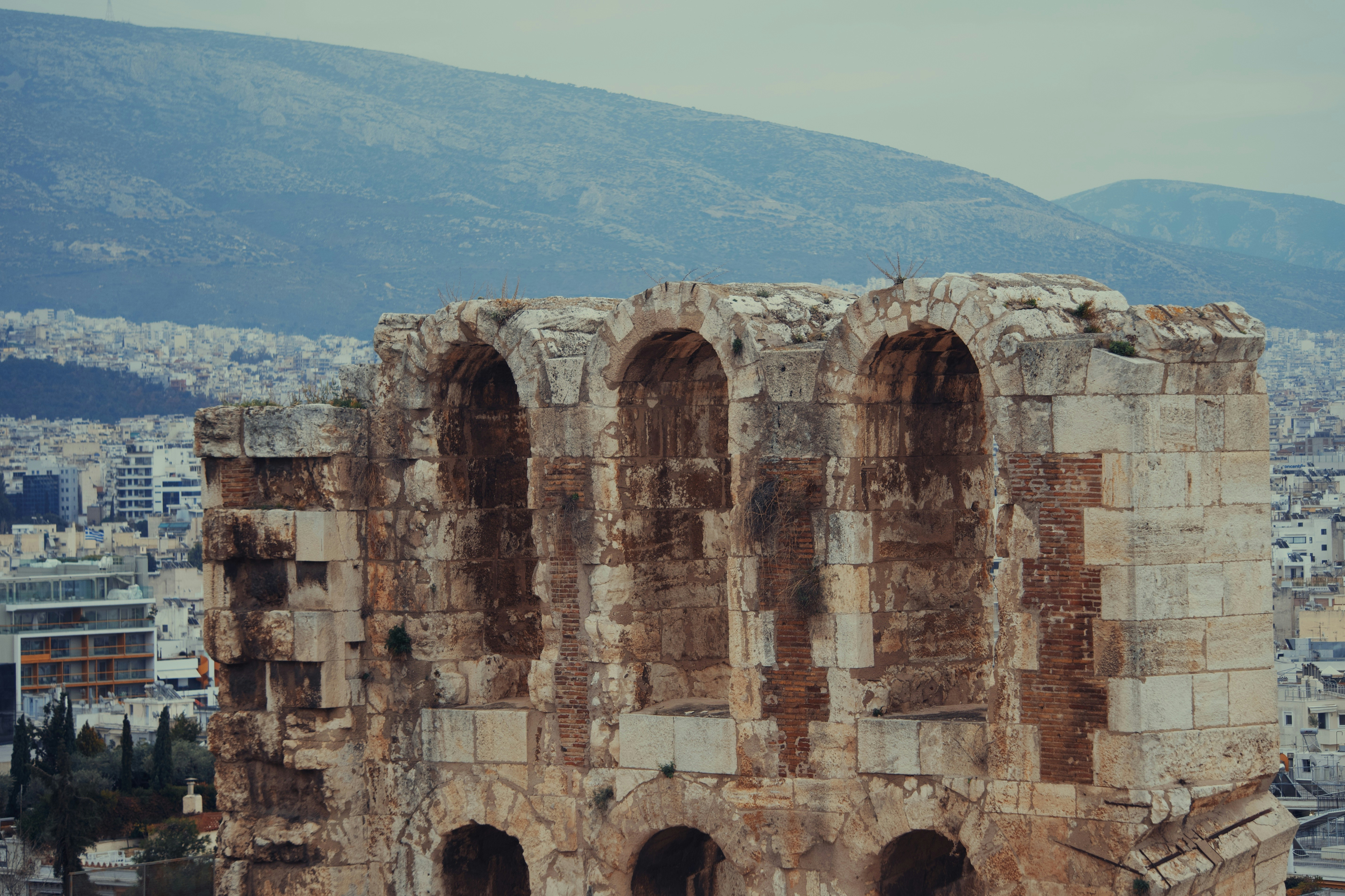A large building with a bunch of windows on top of it, Ancient Crumbling Stone