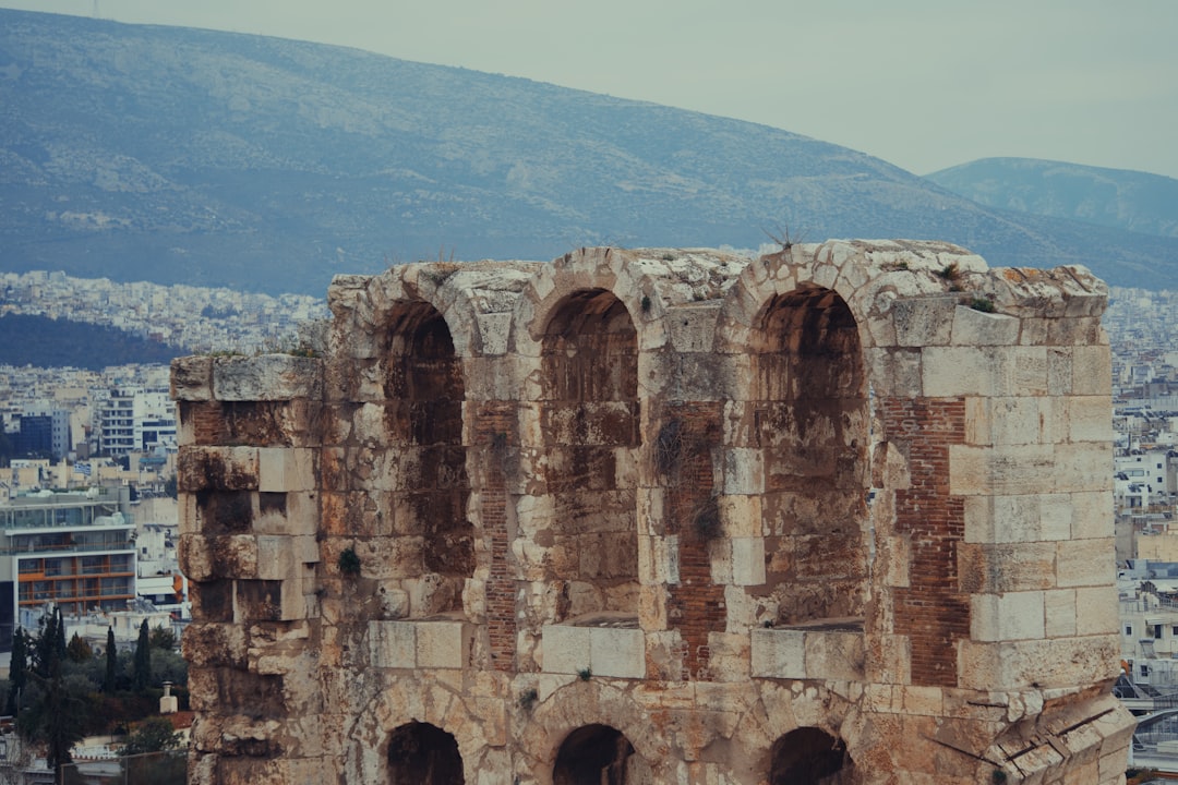 A large building with a bunch of windows on top of it, Ancient Crumbling Stone