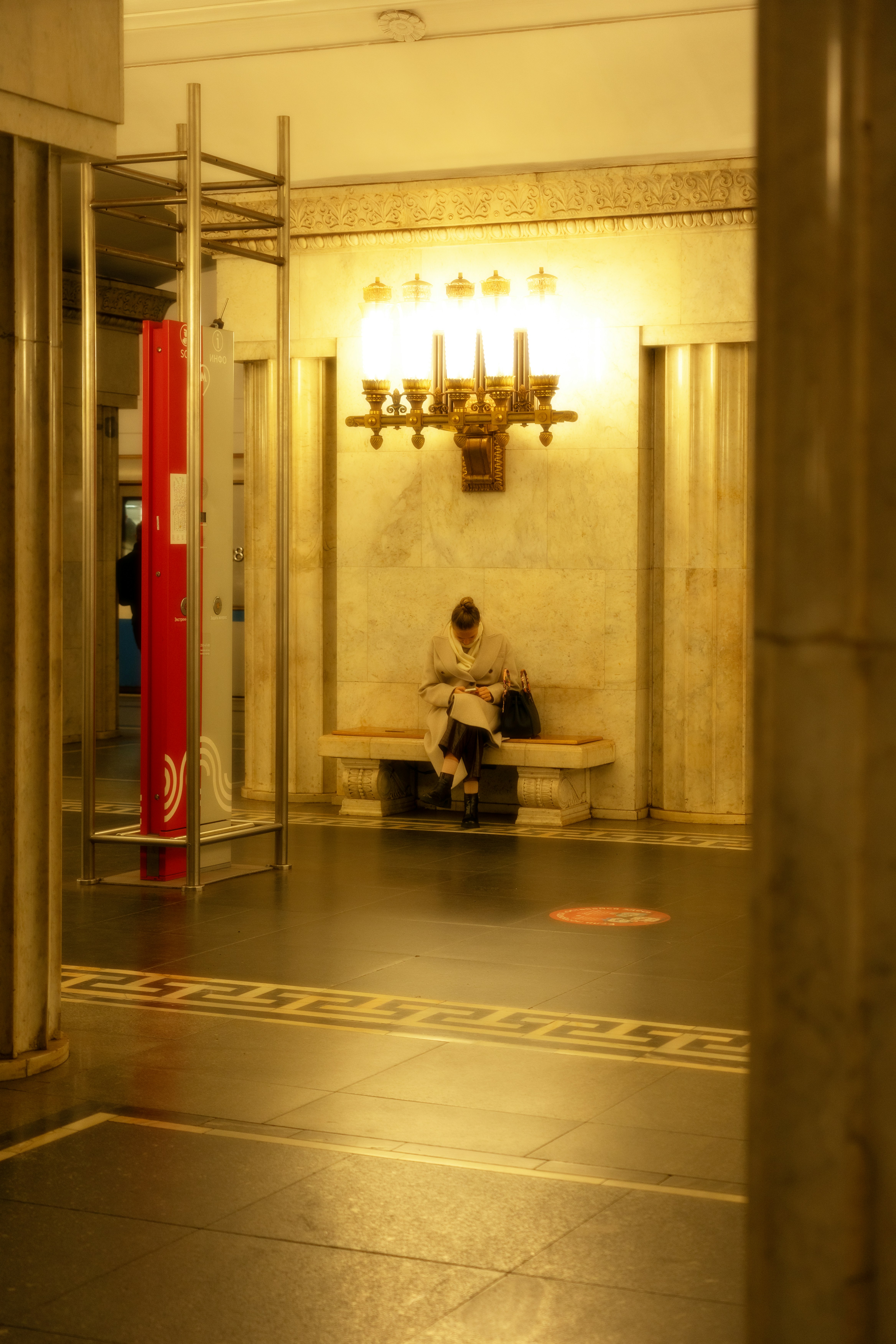A man sitting on a bench in a building