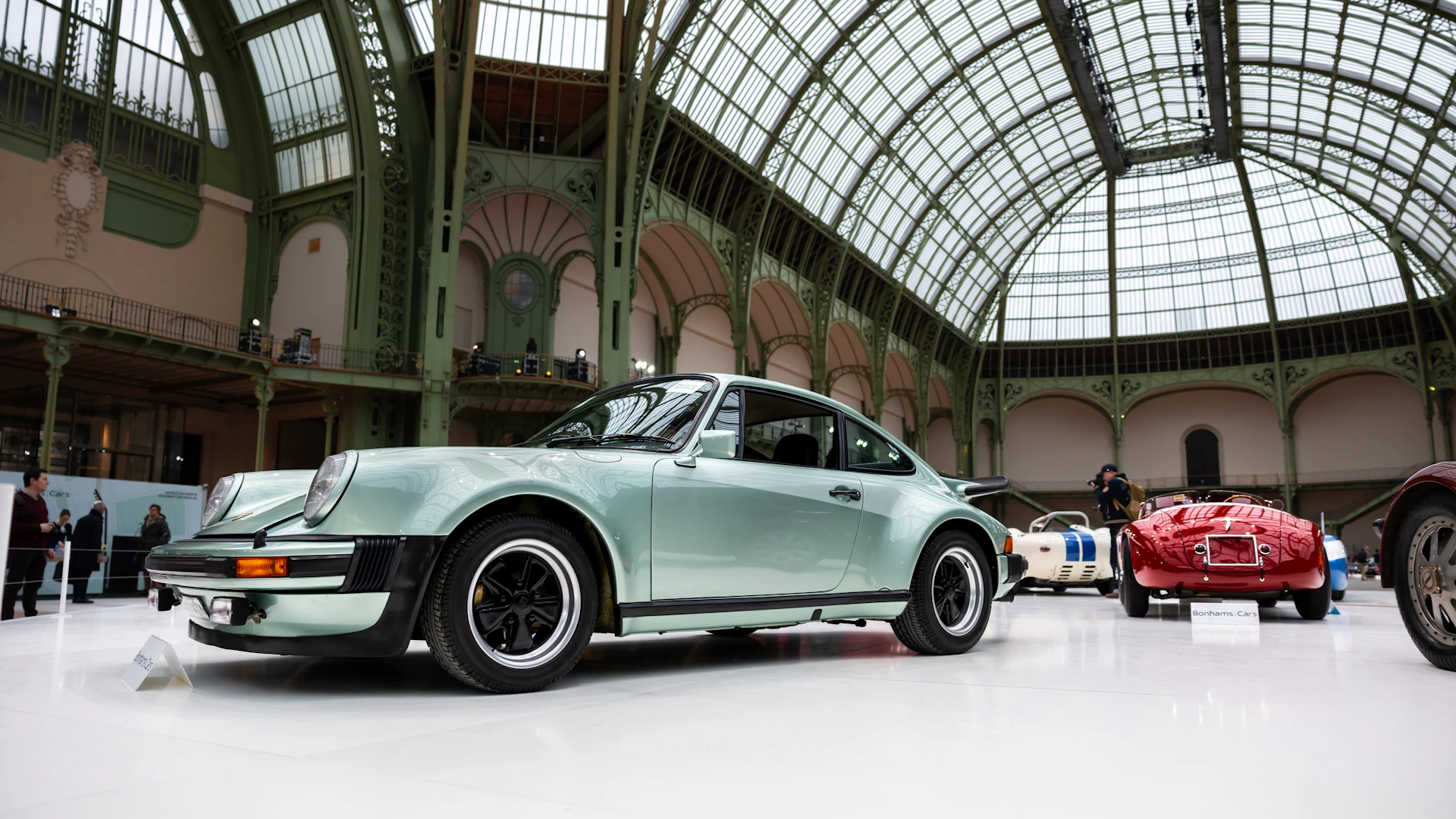 A group of cars parked inside of a building