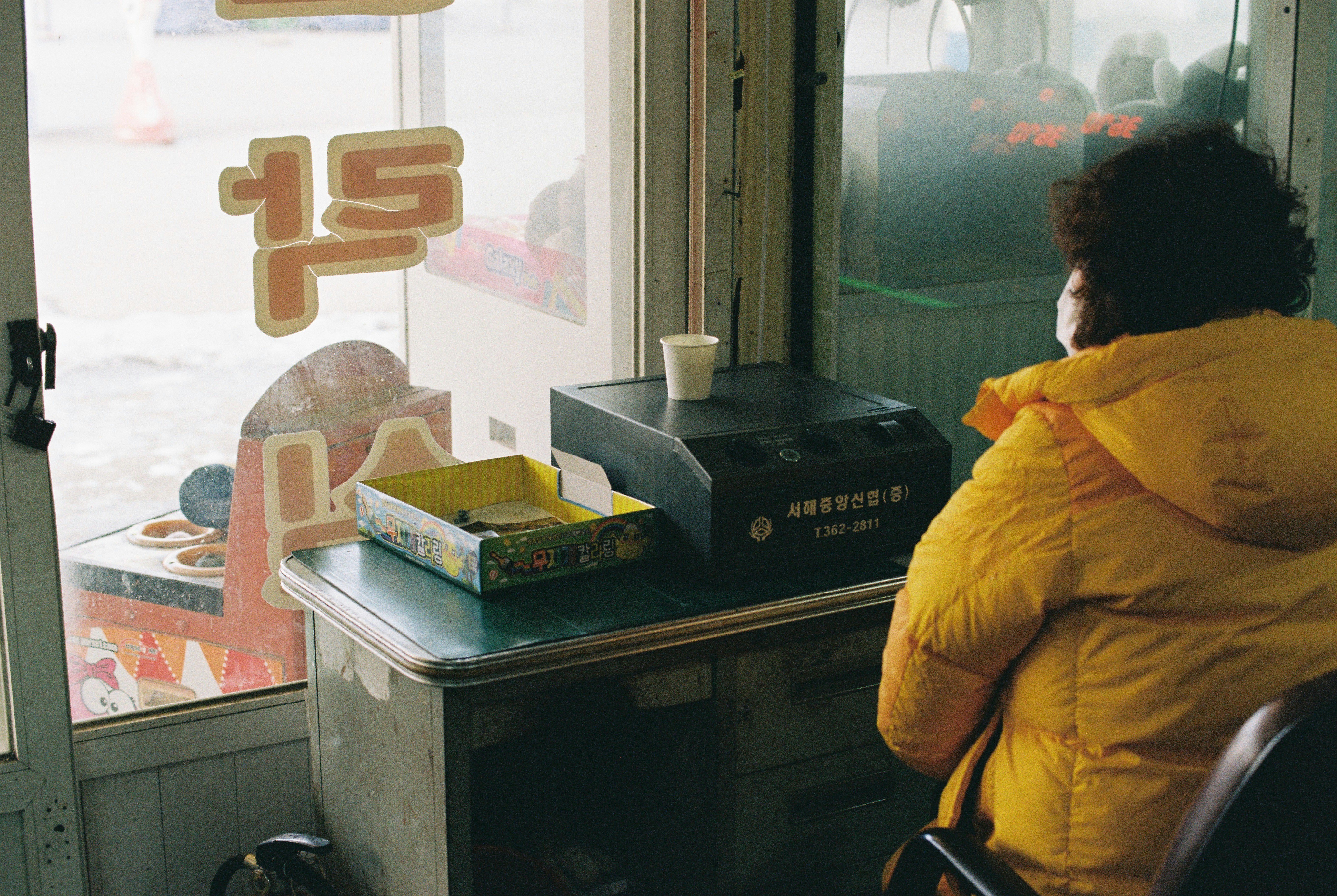 A person sitting in a chair in front of a window