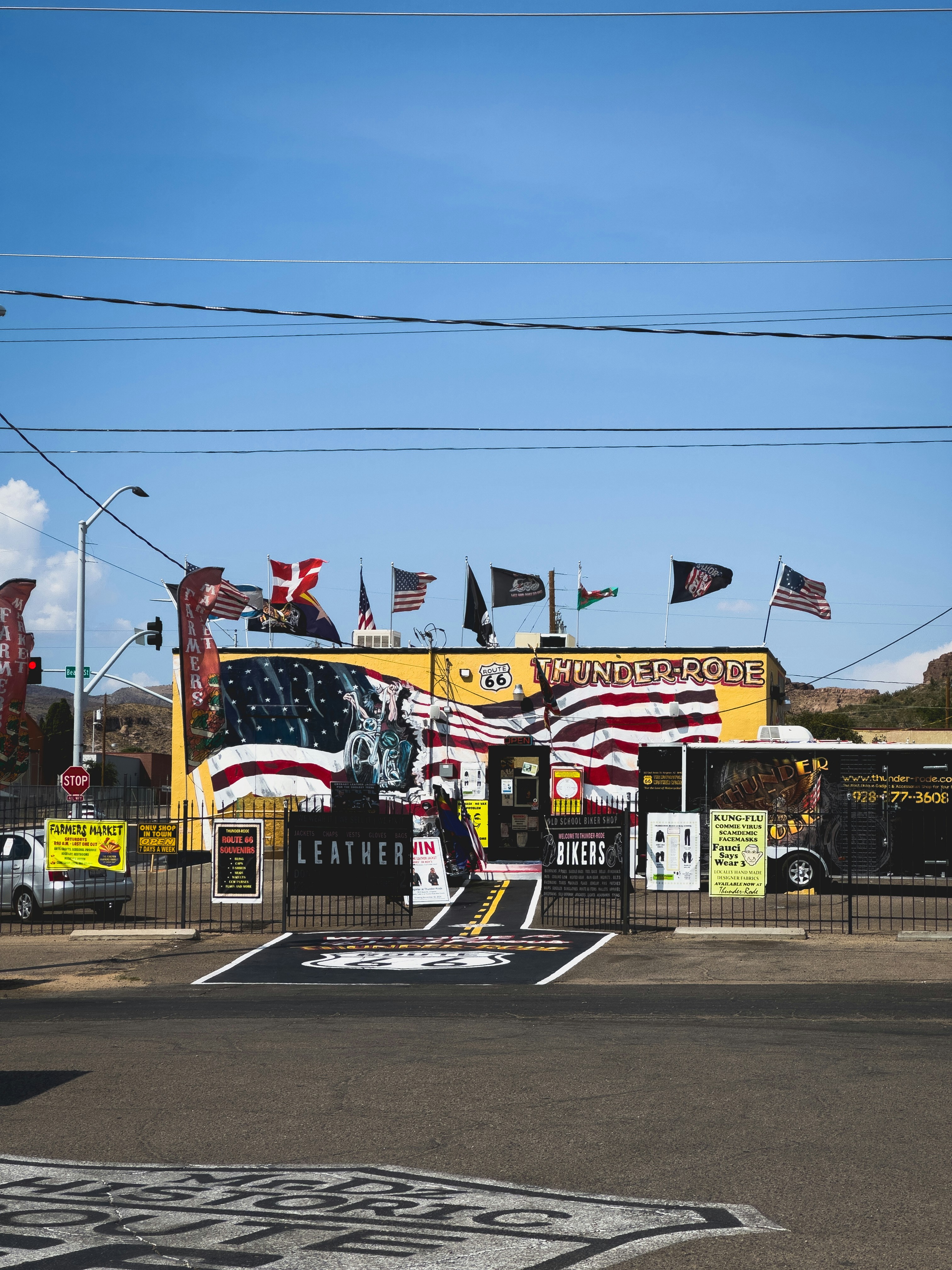 A yellow building with american flags on it
