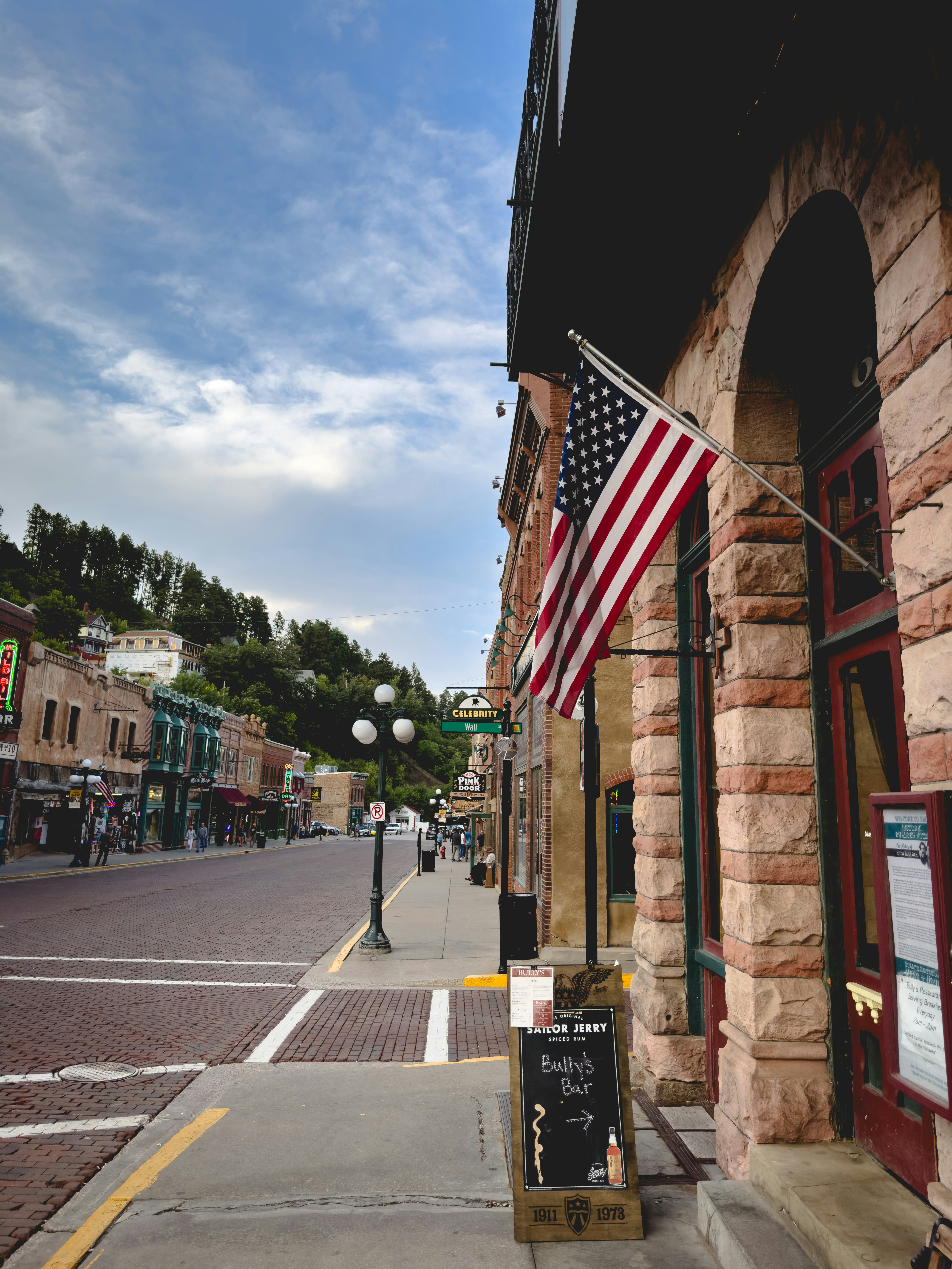 An american flag is hanging on the side of a building