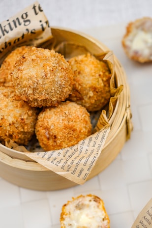 A basket filled with meatballs next to a book