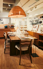 A dining room with a wooden table and chairs