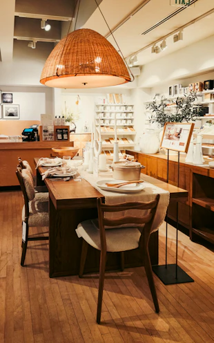 A dining room with a wooden table and chairs
