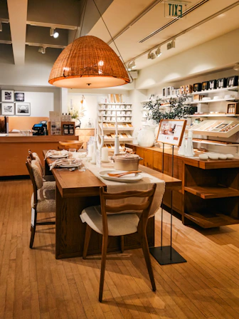 A dining room with a wooden table and chairs