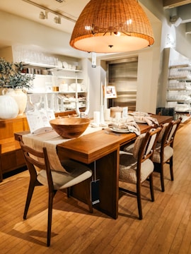 A dining room with a wooden table and chairs