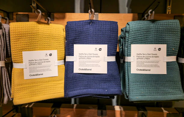 A row of towels hanging on a rack in a store