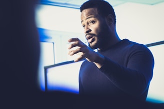 A man standing in front of a projection screen
