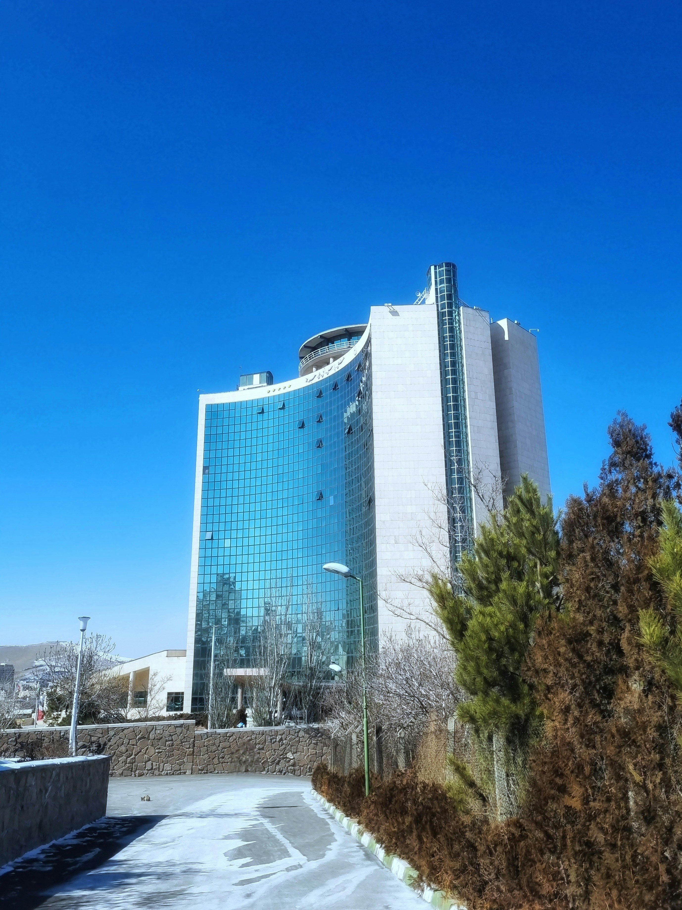 Modern building stands tall against a clear, blue sky.