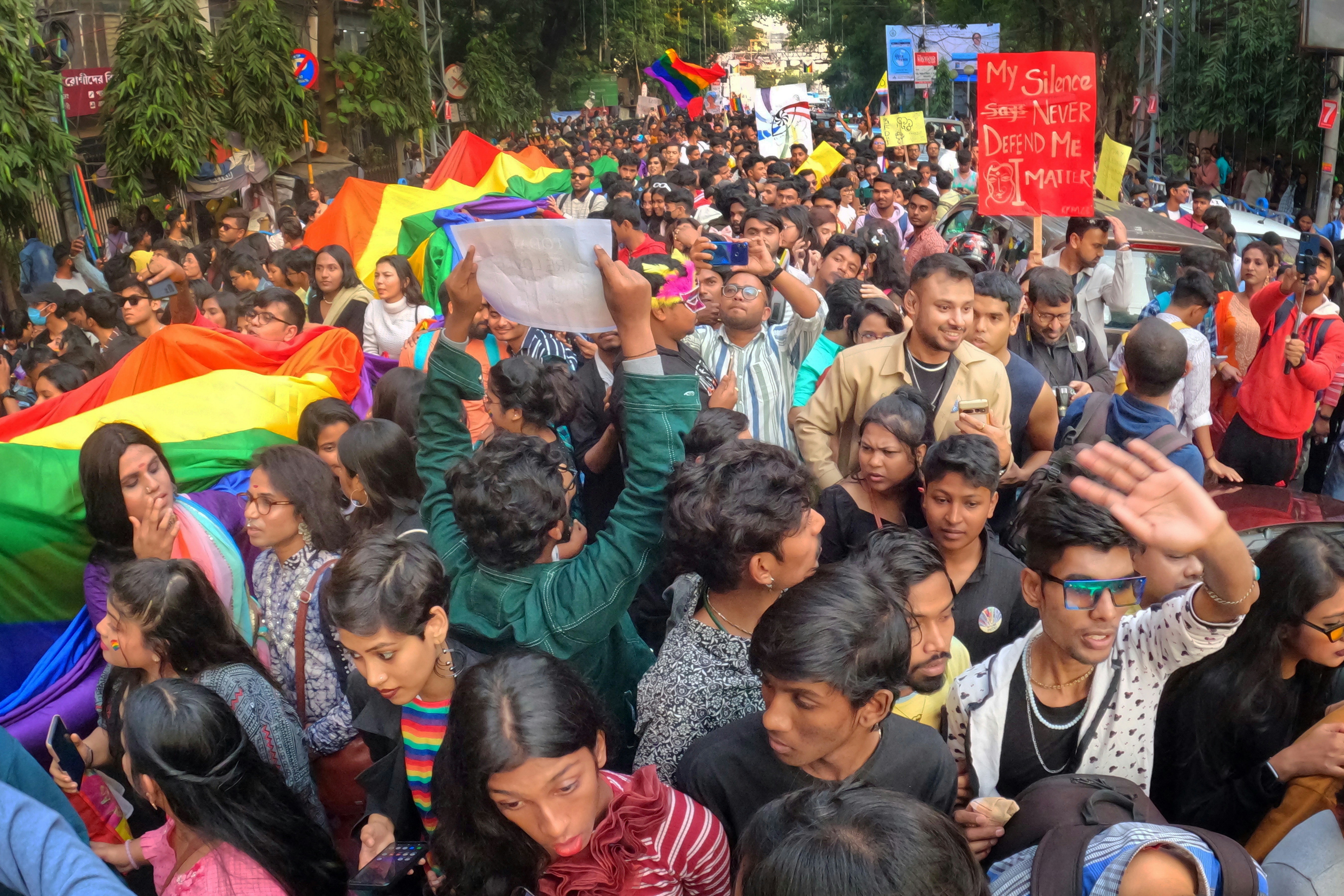 Youth holding rainbow flags in protest