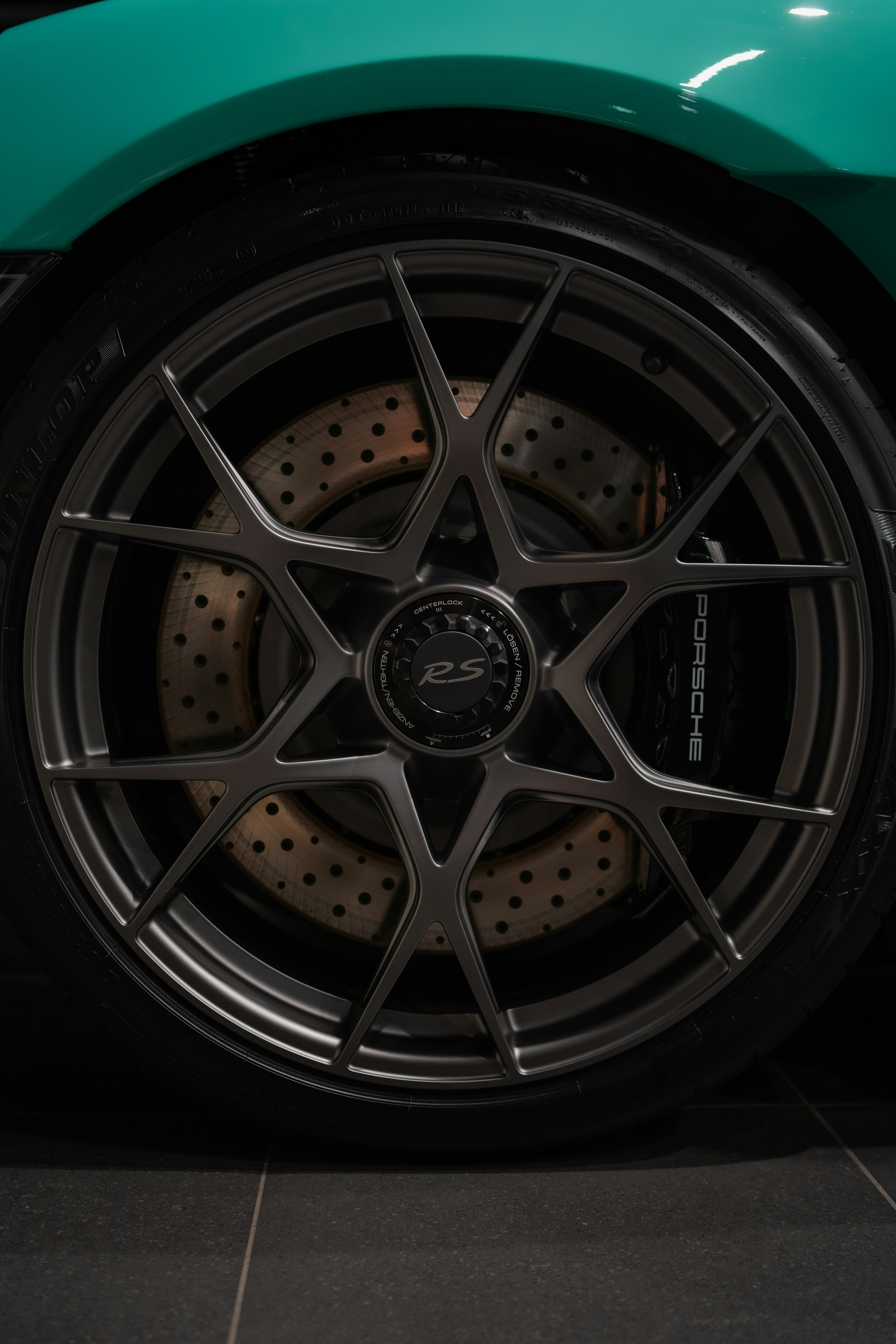 Porsche car wheel detail showcasing its brakes.
