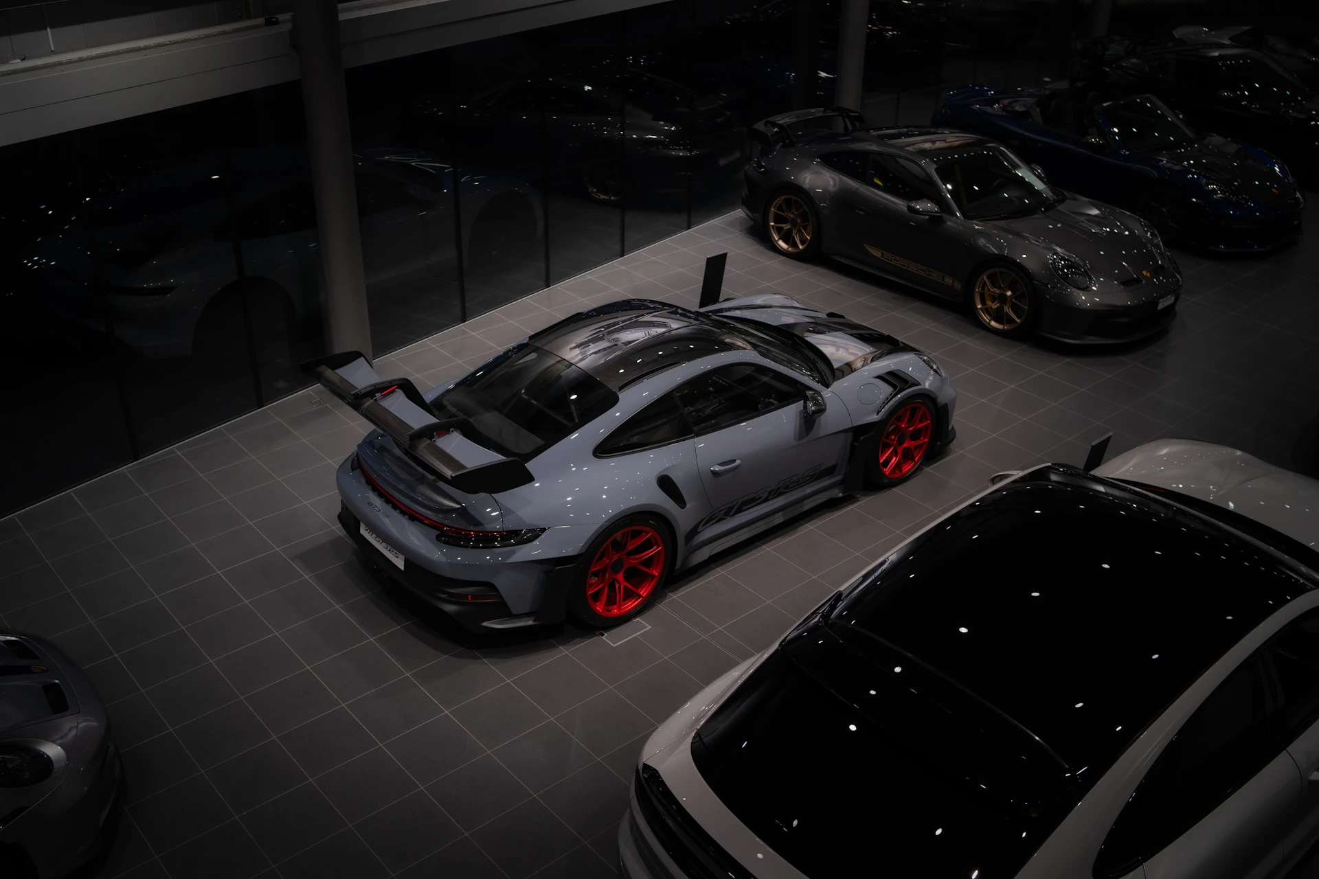 Luxury cars are showcased inside a car showroom.