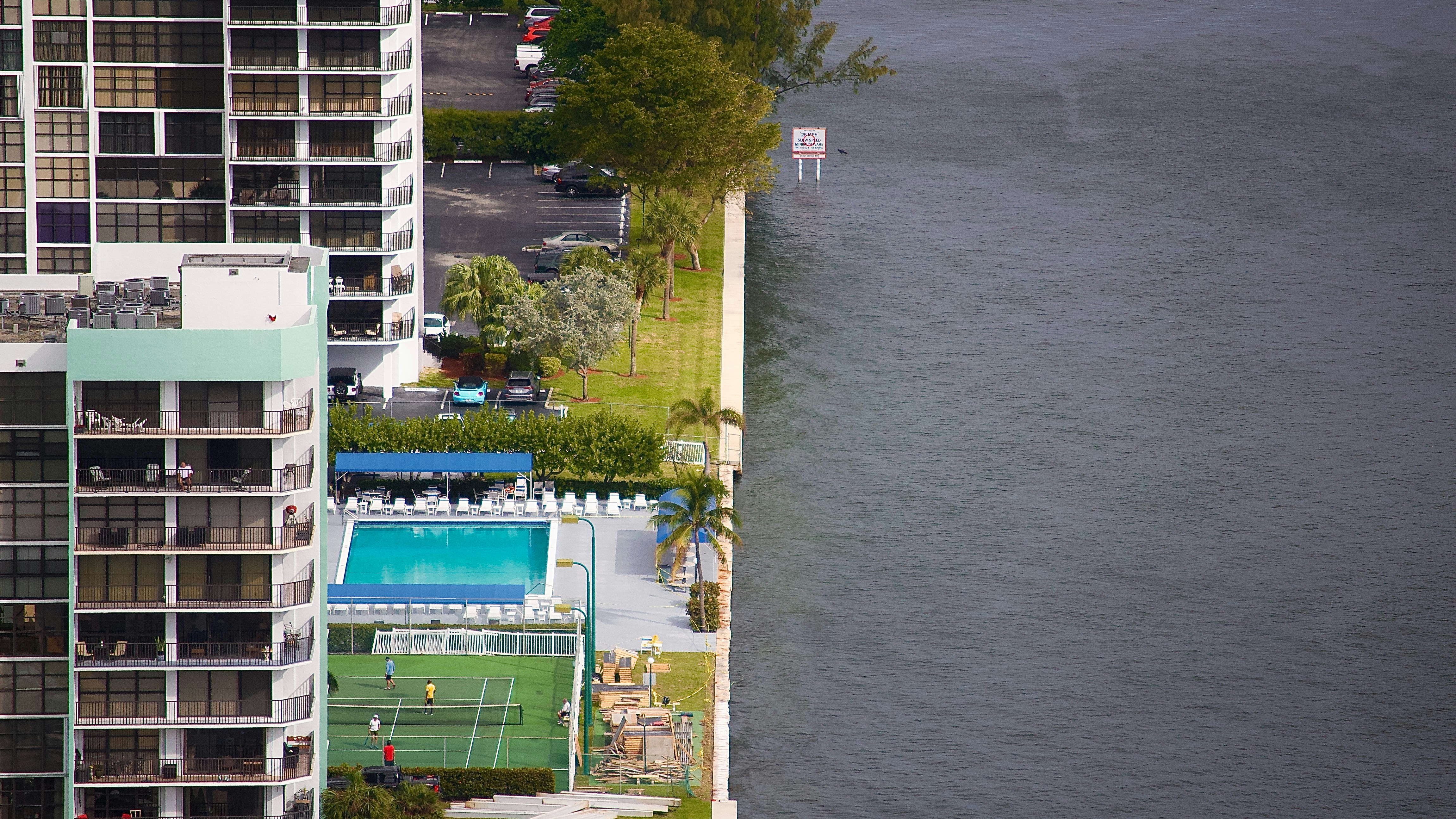A scale balancing a "NFIP" block on one side and a "Private Insurance" block on the other, symbolizing the comparison between the two flood insurance options. - cheap flood insurance quote