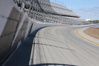 A racetrack curve and grandstands are shown.