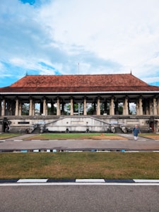 A large building with columns and a red roof