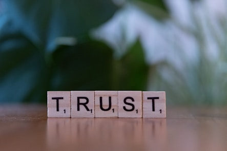 A wooden block spelling trust on a table