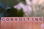 A wooden block spelling consulting on a table