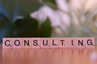 A wooden block spelling consulting on a table