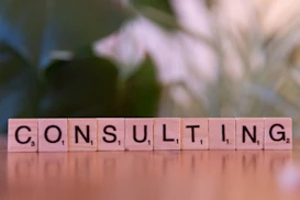 A wooden block spelling consulting on a table