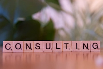 A wooden block spelling consulting on a table
