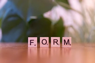 Scrabble letters spelling form on a wooden table