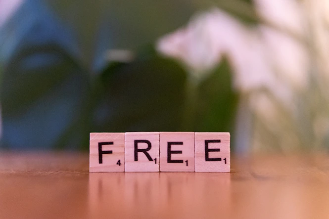 A wooden block that says free sitting on a table