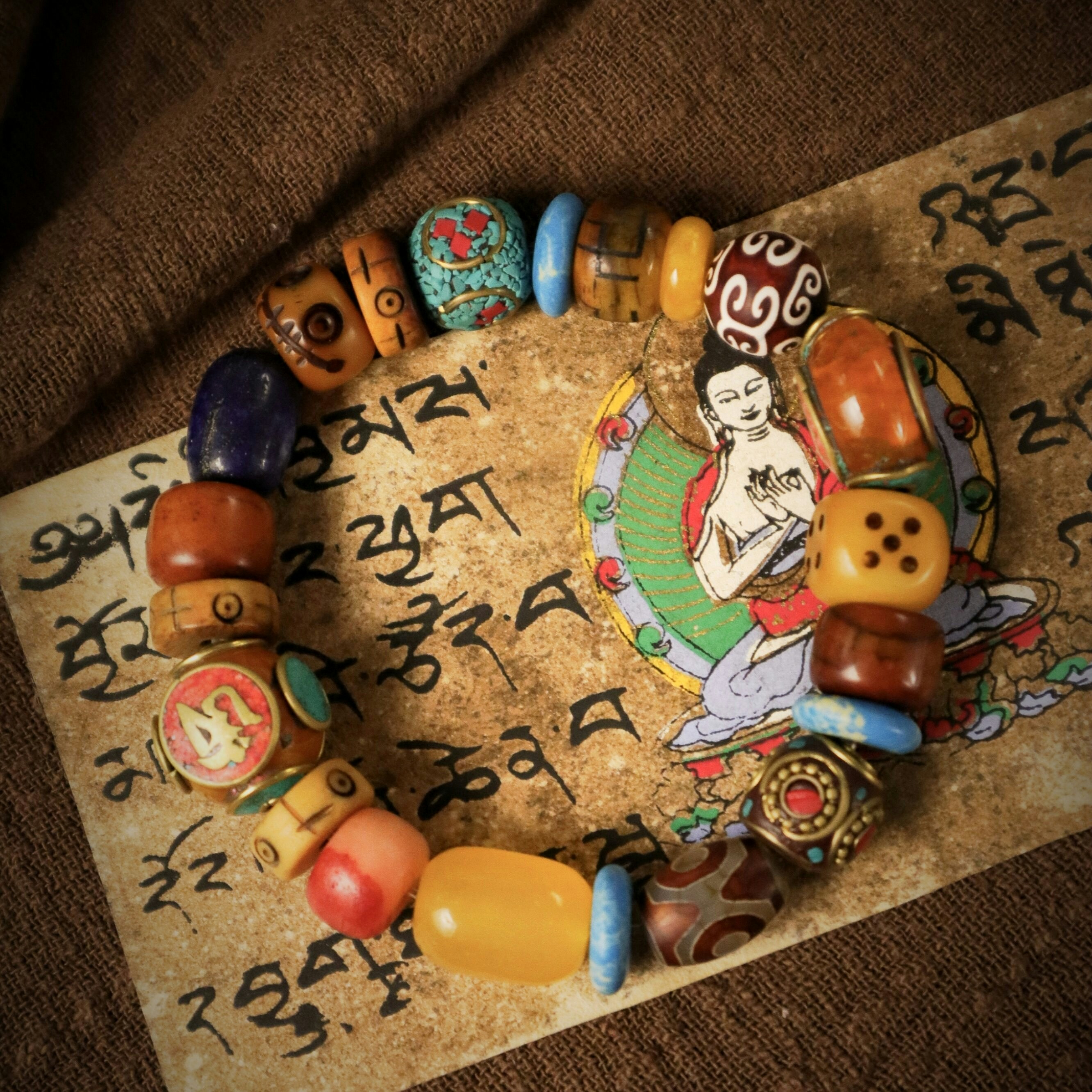 Colorful beaded bracelet on ancient manuscript.