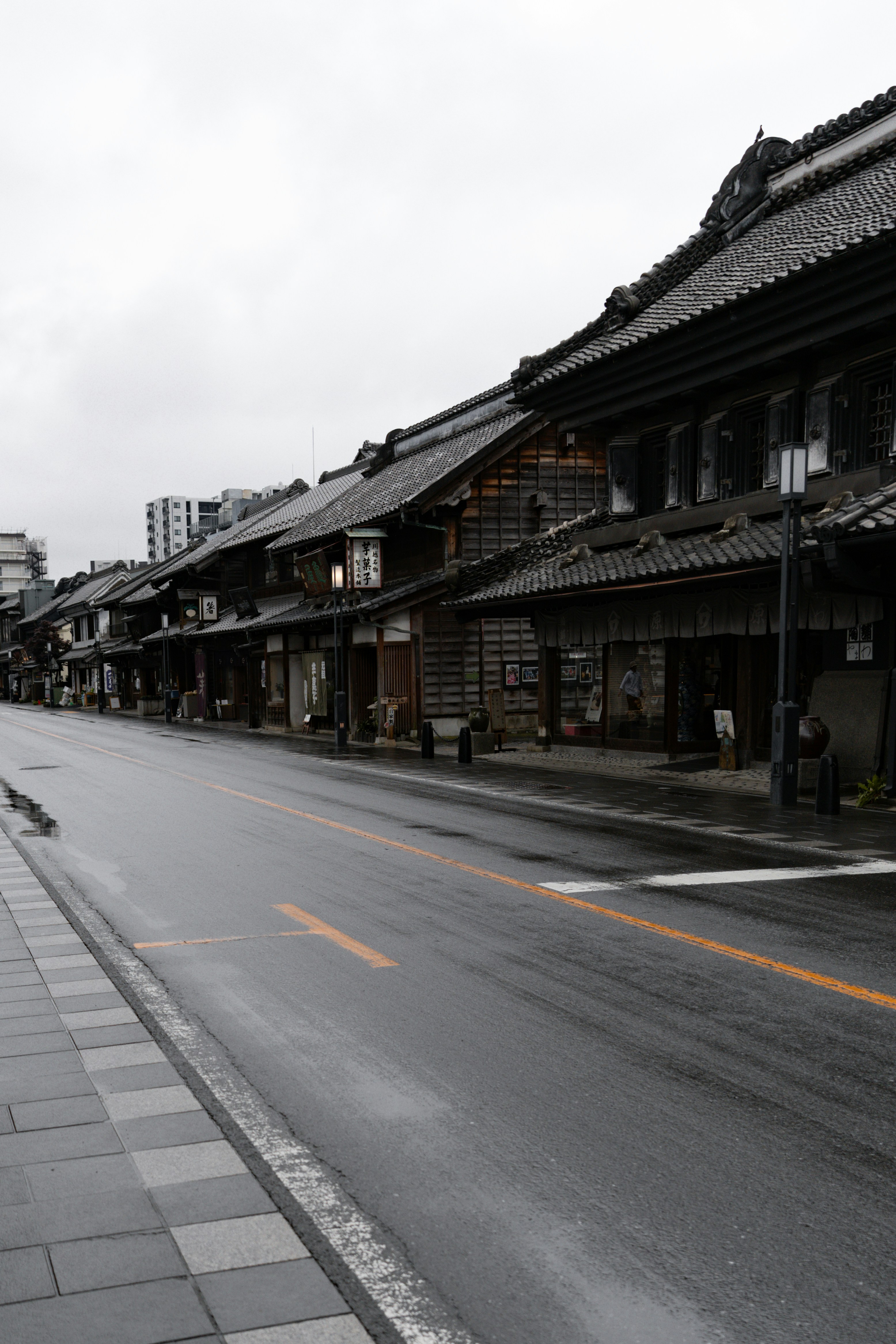 A quiet street lined with traditional japanese buildings.