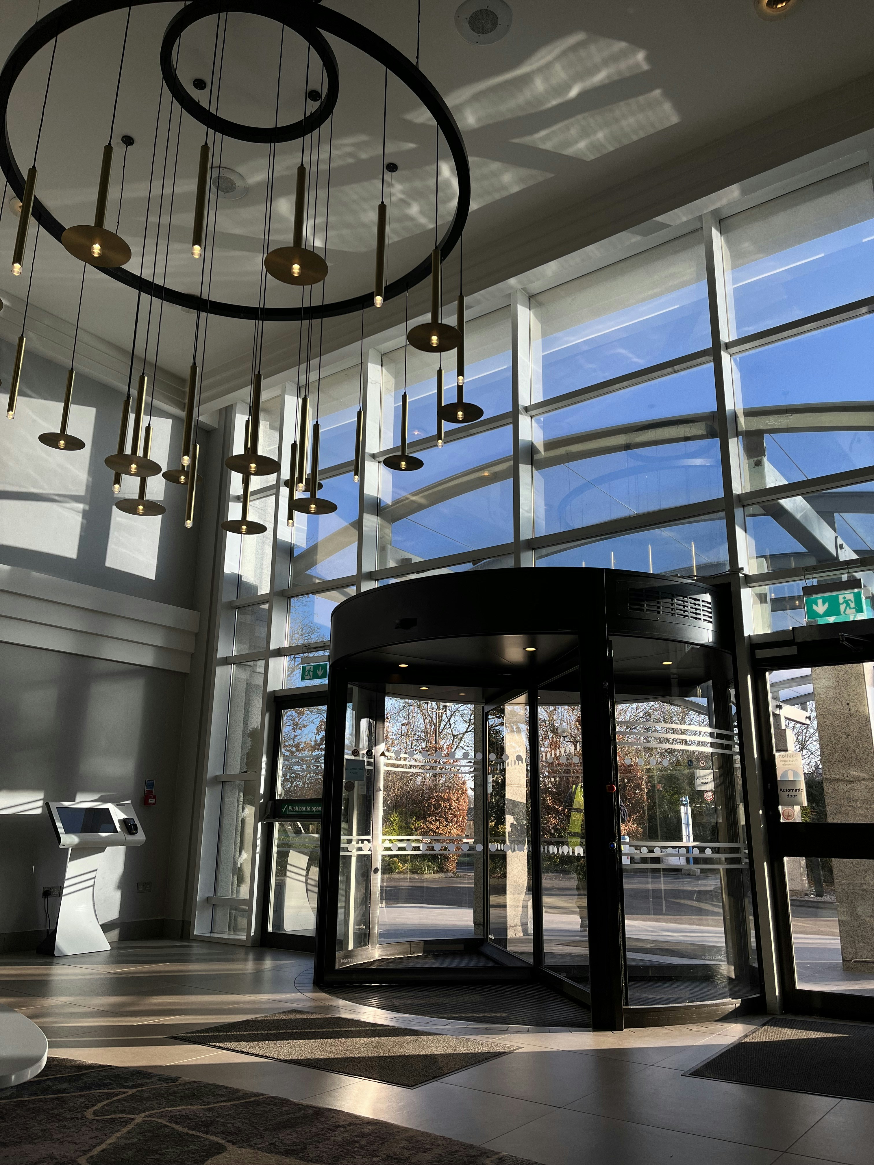 A modern hotel lobby with a revolving door.