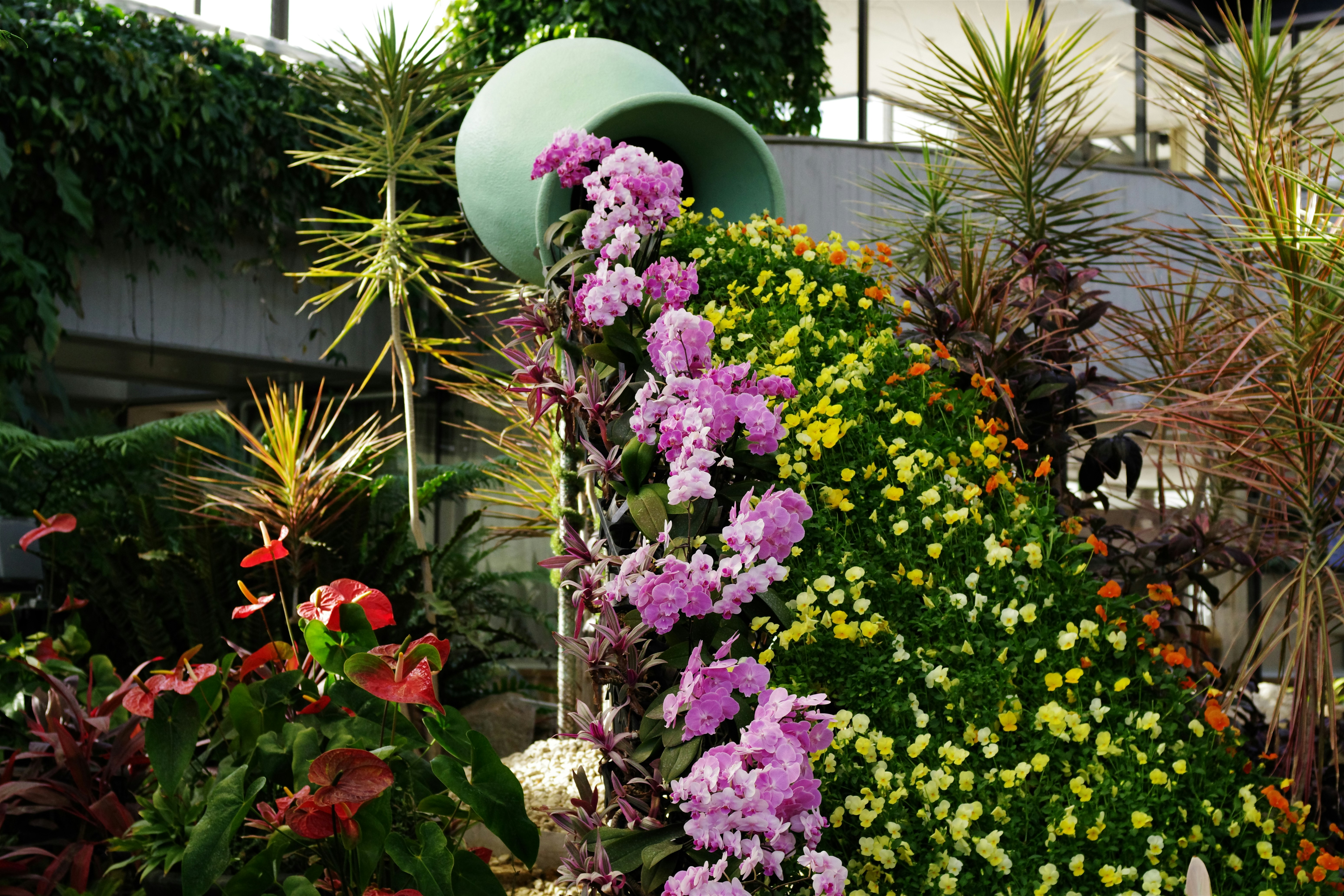 Flowers seem to be spilling out of a large jug.