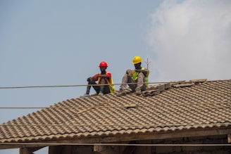 Two construction workers are taking a break.