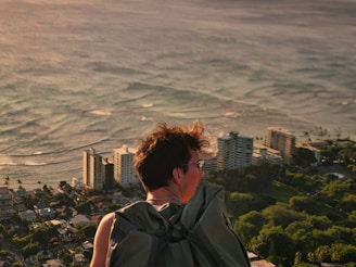 Person gazes at ocean view from a high place.