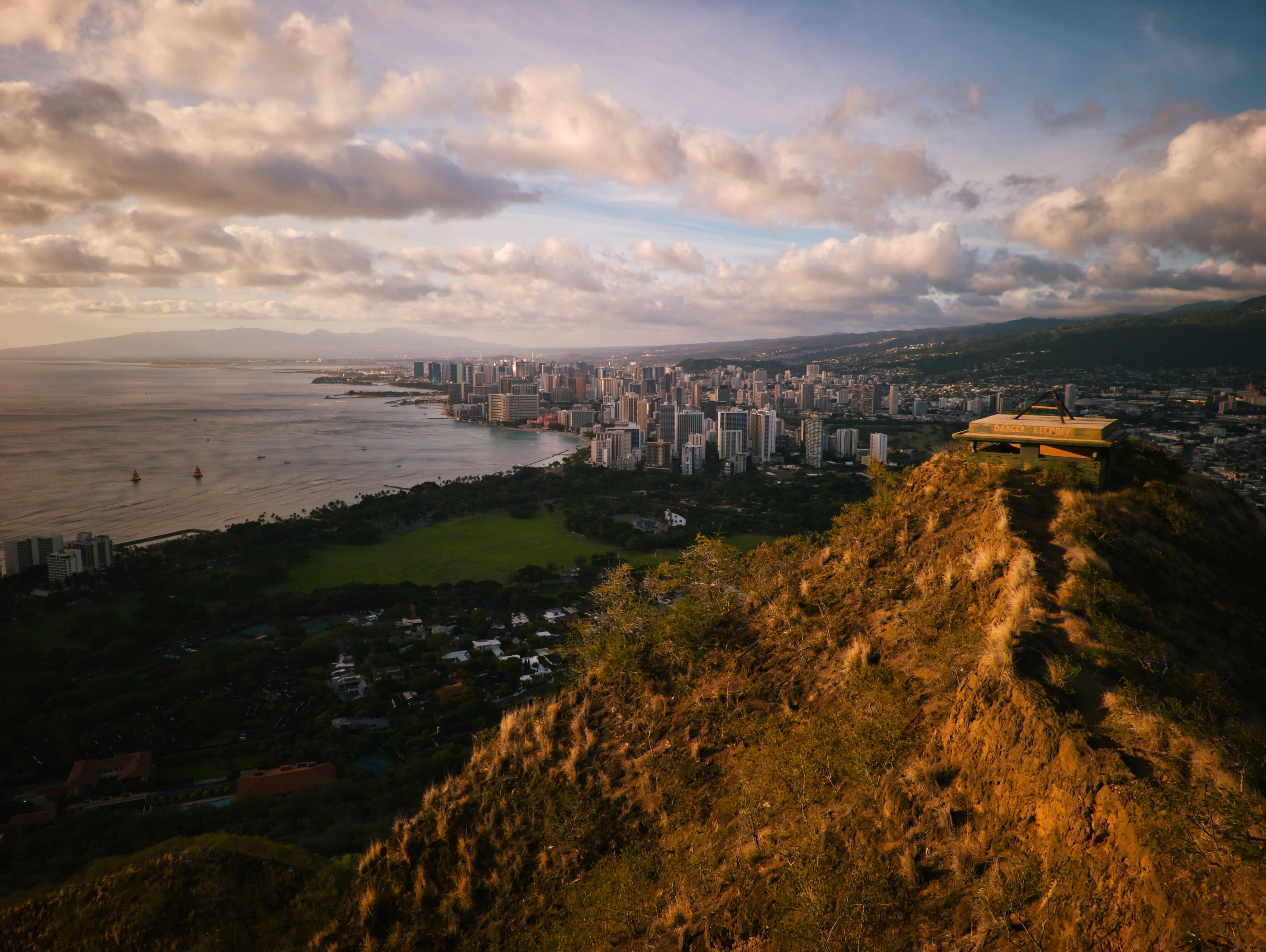 View of city and ocean from a mountain.