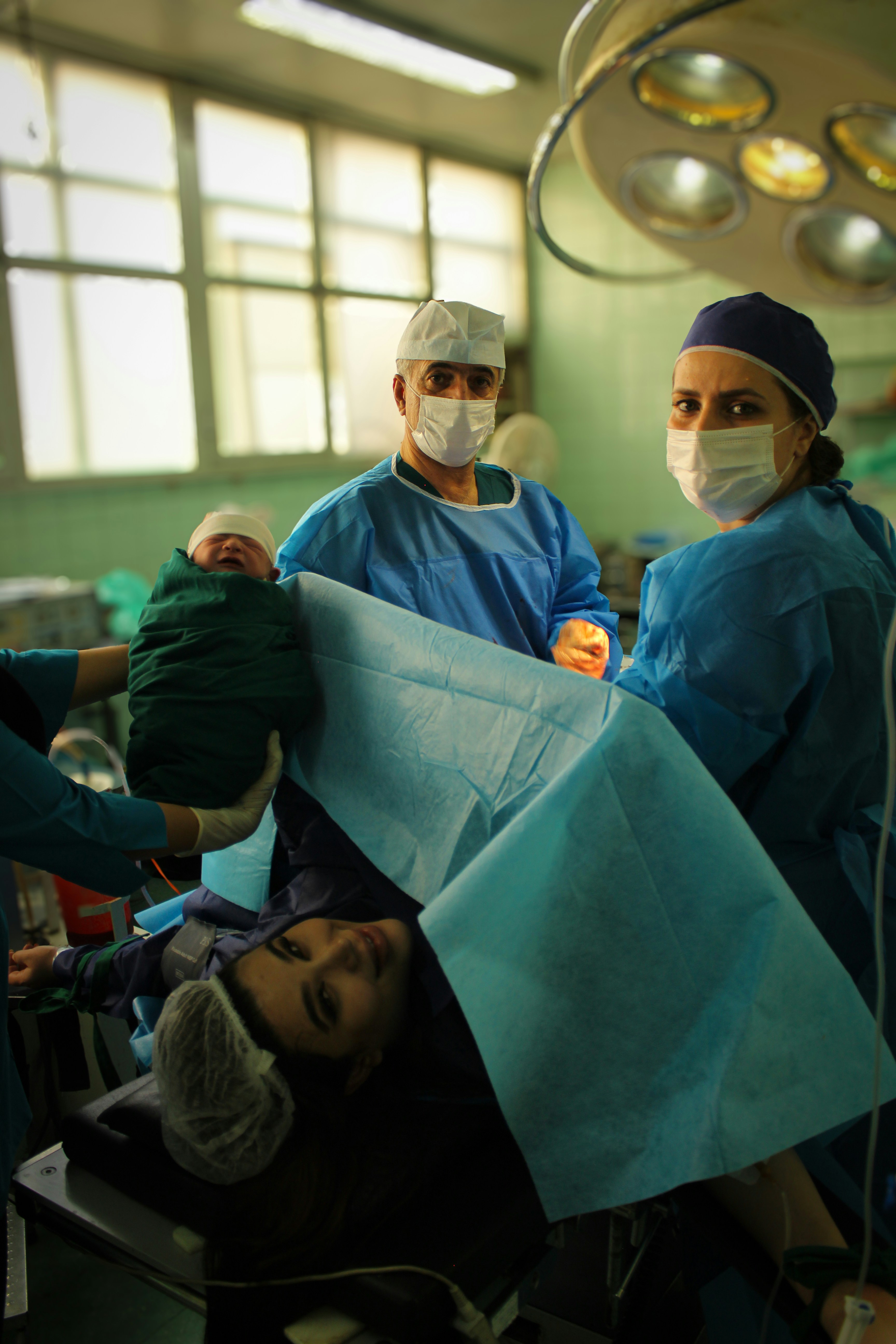 A newborn baby is held after delivery.