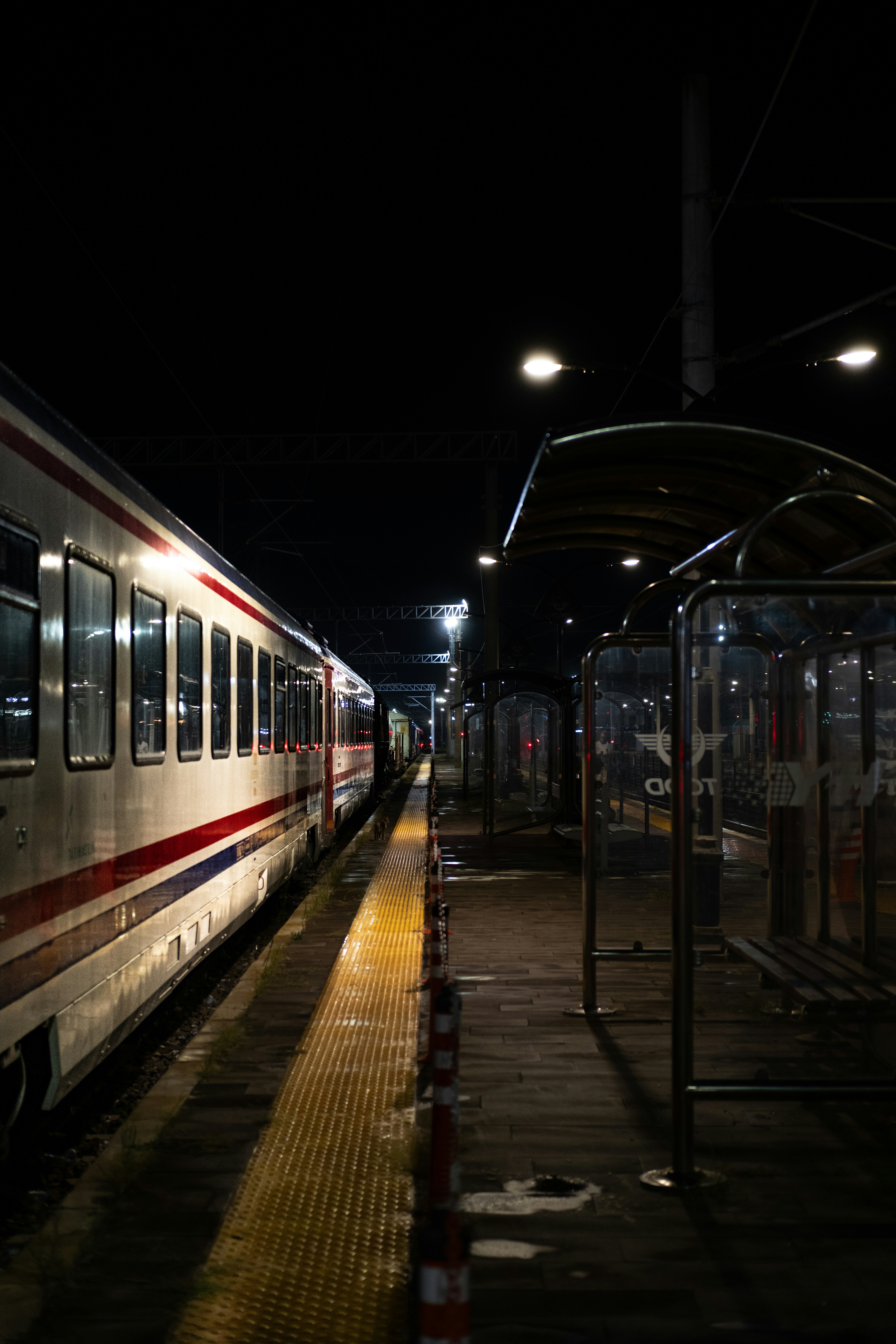 A train sits at an empty platform at night.