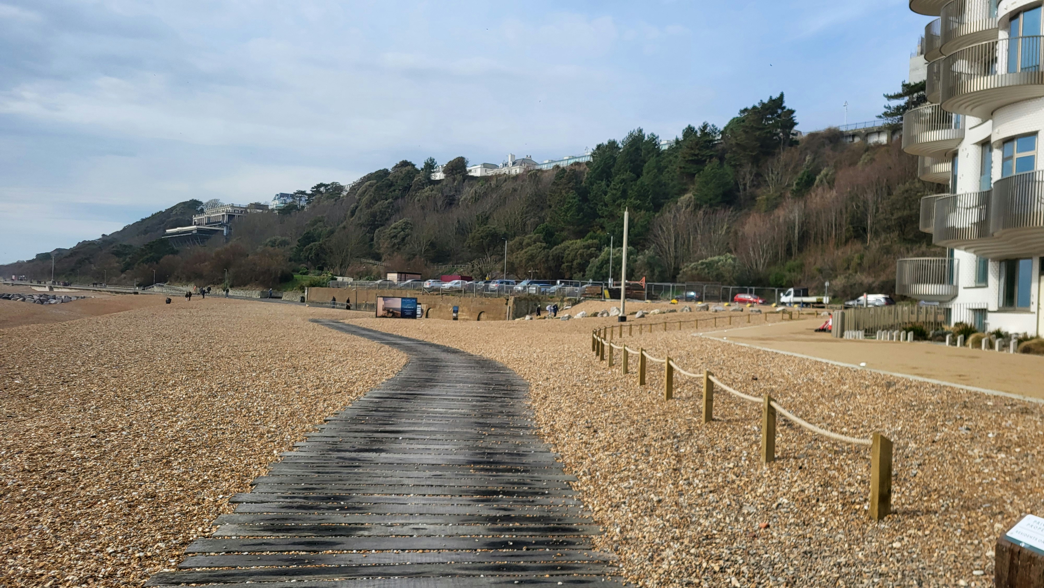 A winding boardwalk leads to a beautiful beach.
