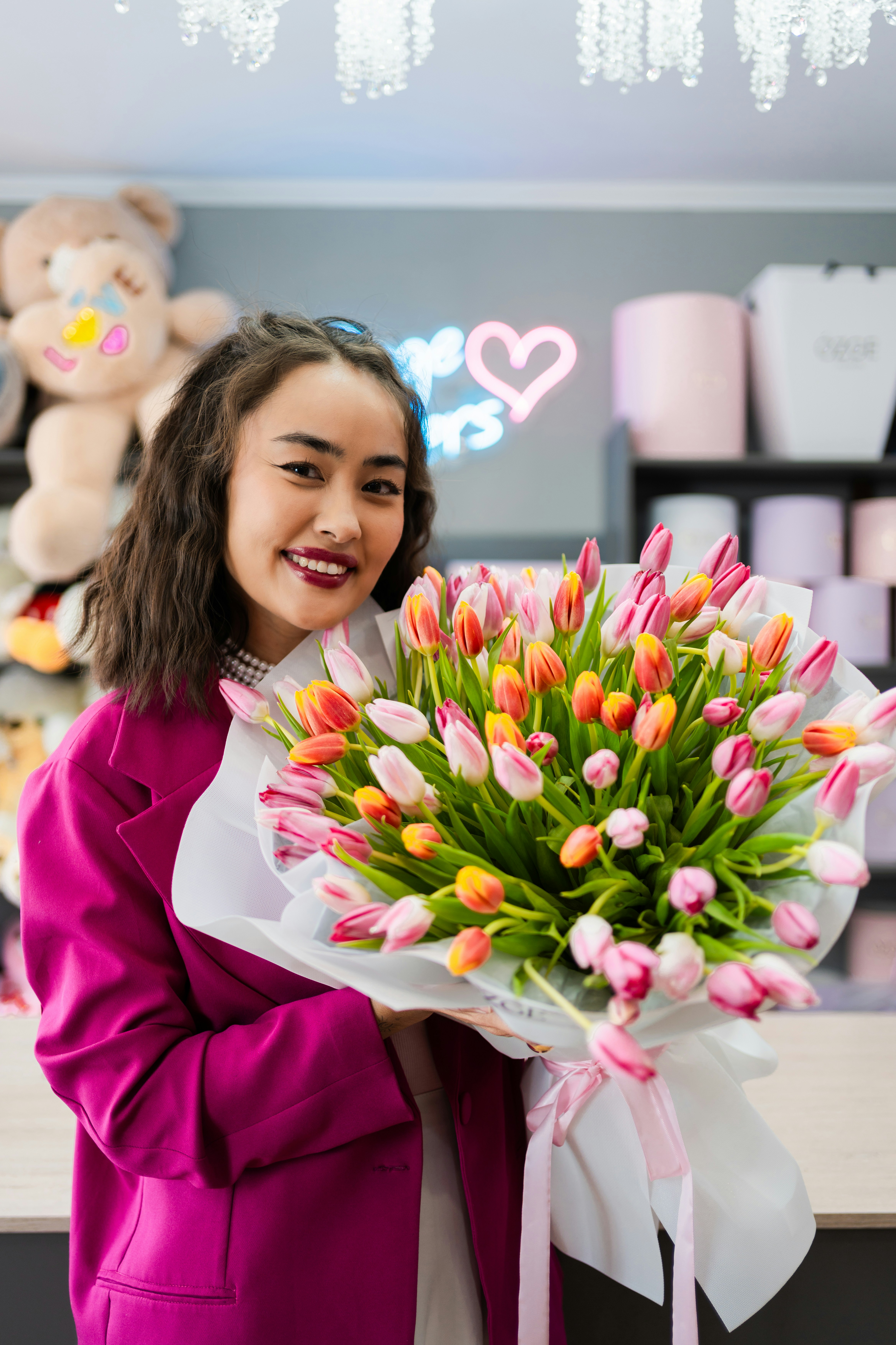 Woman holds a large, beautiful bouquet of tulips.