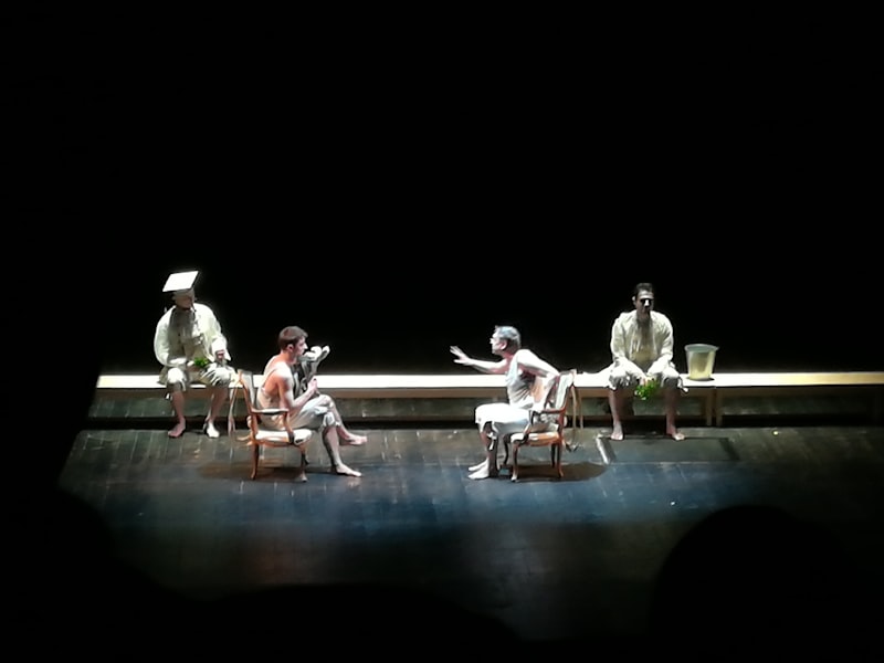 Actors performing a dramatic scene on a theater stage