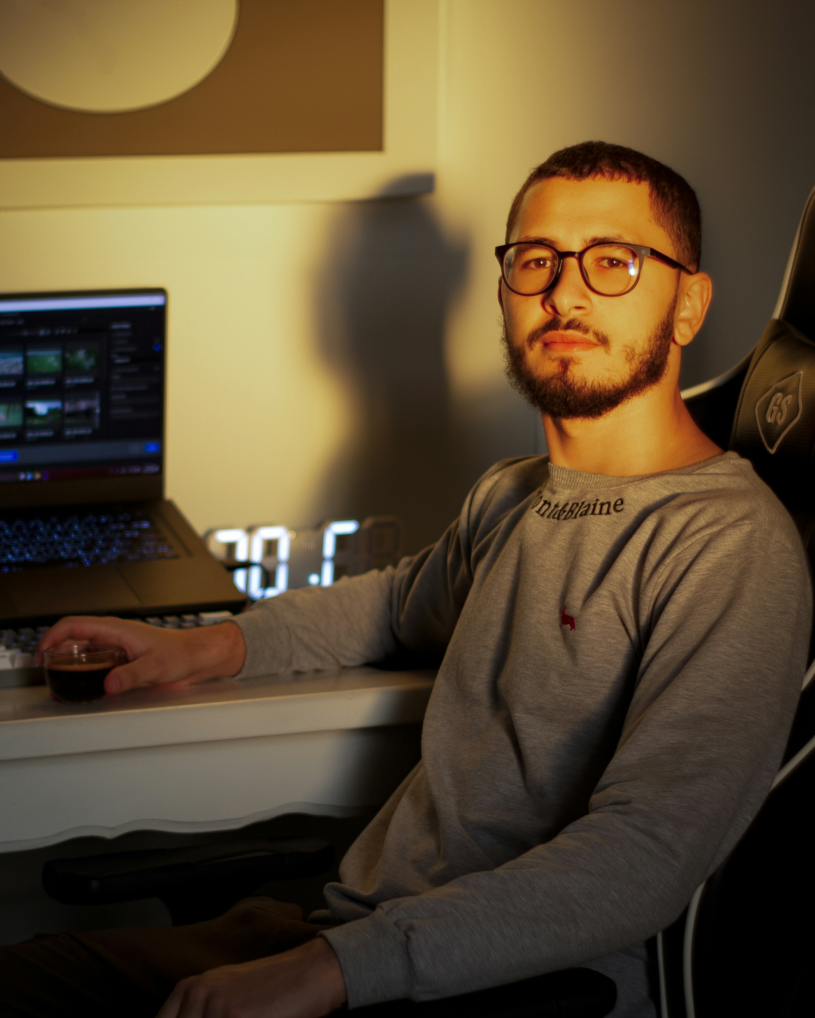 A man sitting in front of a laptop computer