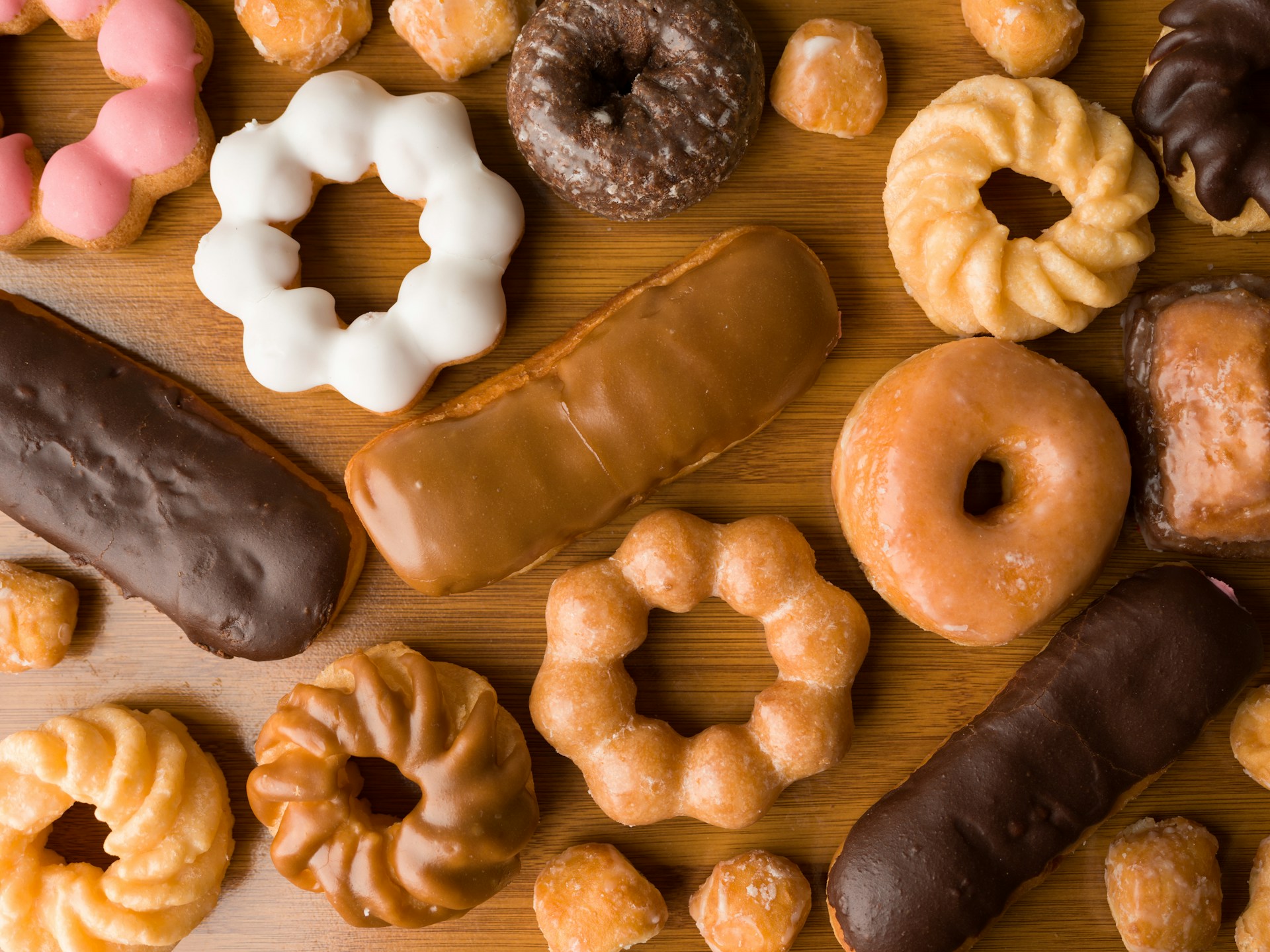 A wooden table topped with lots of different types of donuts