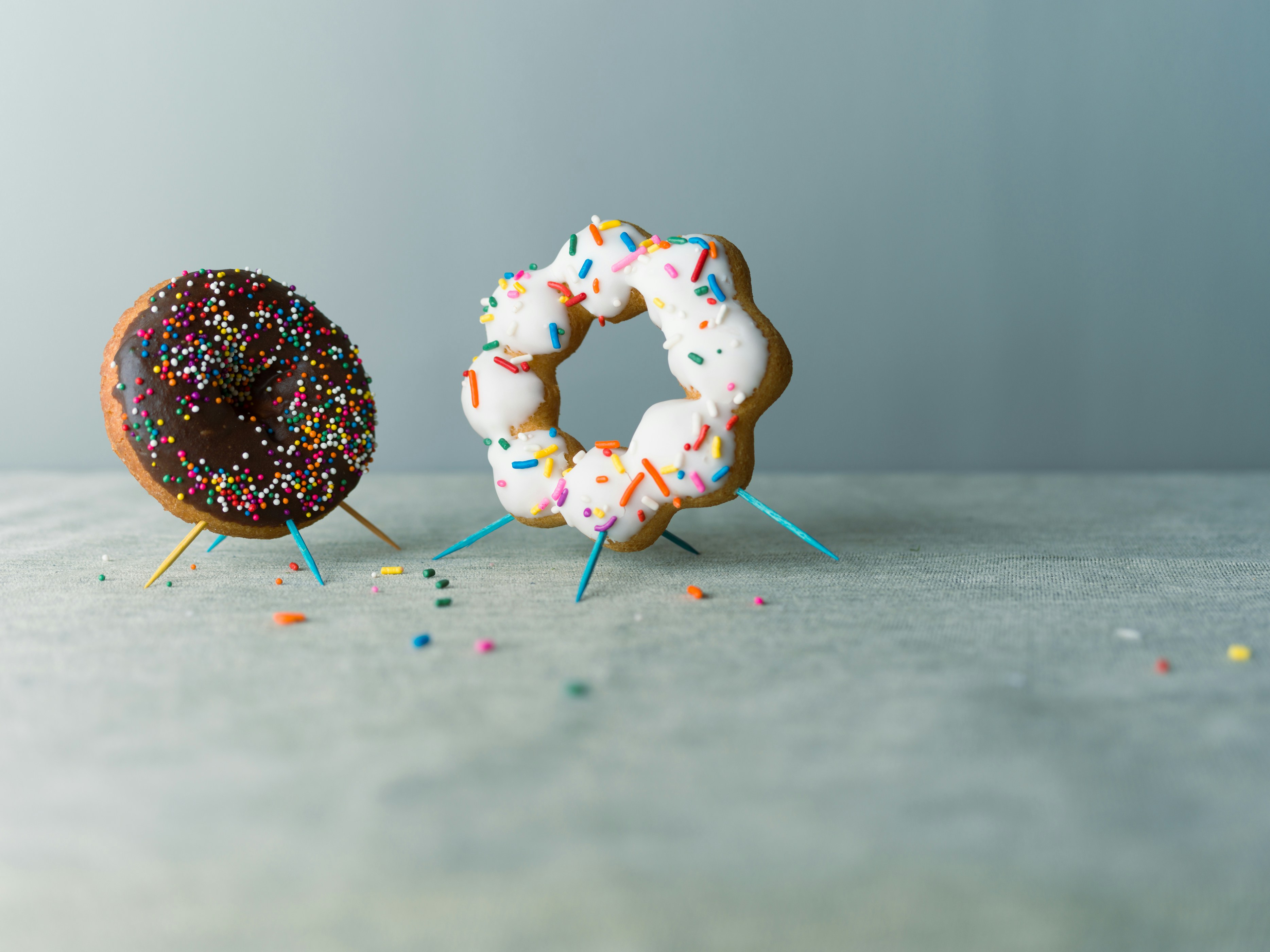 A couple of doughnuts sitting on top of a table